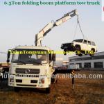Flatbed road wrecker with folding boom