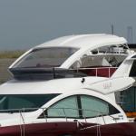 Toma original flybridge cabin cruiser boats tops and motorized windshields covering whole flybridge